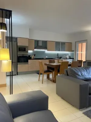 a living room and kitchen with a couch and a table at Cactus Gold Vila Verde in Santa Maria