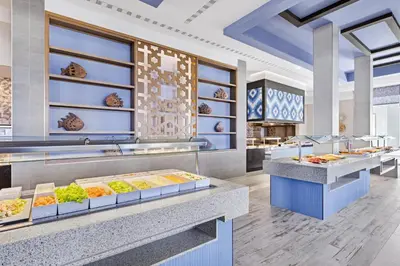 a buffet line in a restaurant with food on display at Hotel Riu Palace Santa Maria - All Inclusive in Santa Maria