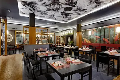 a dining room with tables and chairs and a mural at Hotel Riu Palace Santa Maria - All Inclusive in Santa Maria