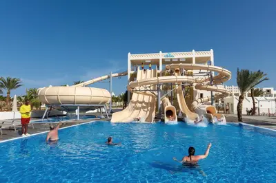 a group of people in a swimming pool at a water park at Hotel Riu Karamboa - Adults Only - All Inclusive in Rabil