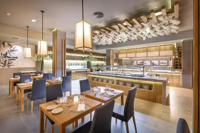 a restaurant with wooden tables and chairs and a kitchen at Hotel Riu Karamboa - Adults Only - All Inclusive in Rabil