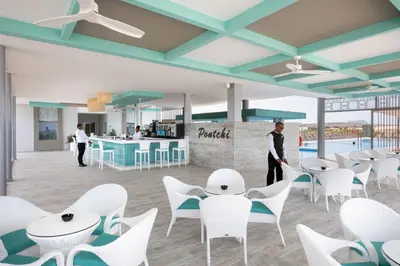 a rendering of a restaurant with white chairs and tables at Hotel Riu Palace Boavista - All Inclusive in Boa Ventura
