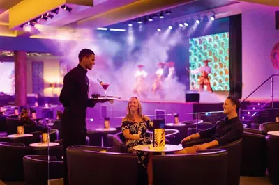 a man giving a presentation in a restaurant with people at Hotel Riu Palace Boavista - All Inclusive in Boa Ventura