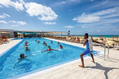 a group of people in a swimming pool near the beach at Hotel Riu Palace Boavista - All Inclusive in Boa Ventura