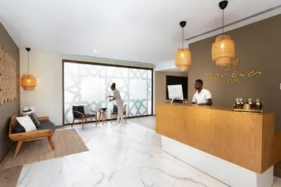 a lobby of a spa with a woman standing at a counter at Hotel Riu Palace Boavista - All Inclusive in Boa Ventura