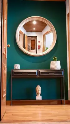 a mirror on a green wall in a room at Spacious Penthouse with BBQ and Views in Praia