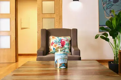 a chair and a table with a vase on top of it at Spacious Penthouse with BBQ and Views in Praia