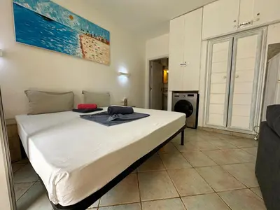 a bedroom with a large bed in a room at Raio Do Sol - Beach front studio with city view in Santa Maria