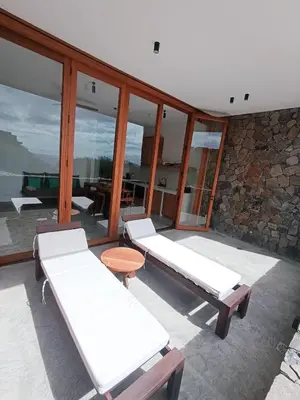 a room with two beds and glass windows at São Pedro Bay in Mindelo