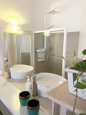 a bathroom with a white tub and a sink at Villa Alfredo Marchetti 13B in Cabeçadas
