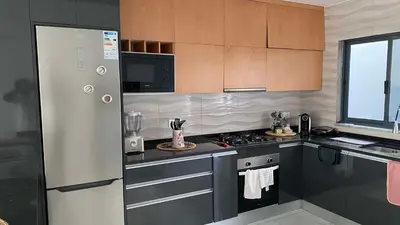 a kitchen with a refrigerator and a stove top oven at Apartamento Casa Sabi in Praia