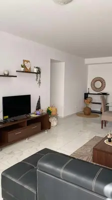 a living room with a couch and a flat screen tv at Apartamento Casa Sabi in Praia