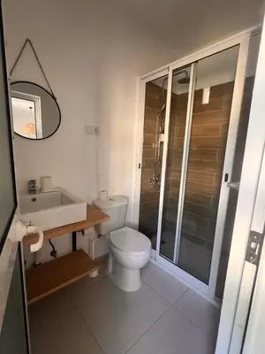a bathroom with a toilet and a sink and a shower at Bed and breakfast Residencial Maravilha in Mindelo
