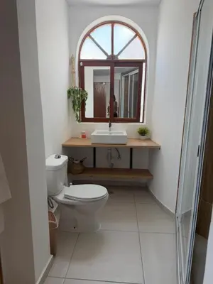 a bathroom with a toilet and a sink and a mirror at Bed and breakfast Residencial Maravilha in Mindelo