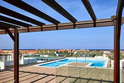 a view of a swimming pool from the balcony of a house at Apartamentos Golfinho Dourado `Edifício Lux,s in Santa Maria