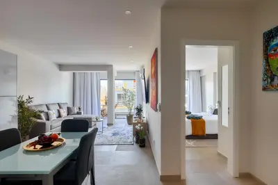 a living room with a dining table and a living room at Apartamentos Golfinho Dourado `Edifício Lux,s in Santa Maria