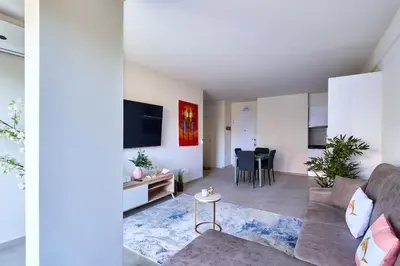 a living room with a couch and a table at Apartamentos Golfinho Dourado `Edifício Lux,s in Santa Maria