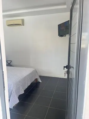 a room with a table and a tiled floor at Apto Duarte quarto no terraço in Praia