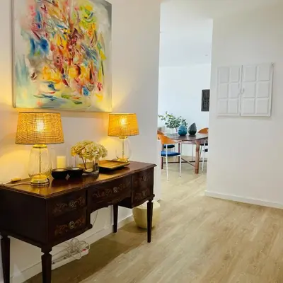 a desk with two lamps and a painting on the wall at Sal Little Heart Grand Terrace Apartment 26 in Santa Maria