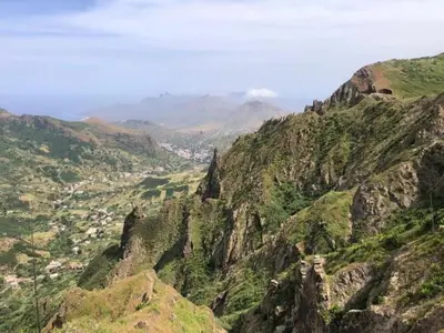a view of a mountain range with a town in the distance at Conforto ,Natureza e Relaxamento in Carvoeiros