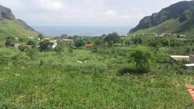 a field of grass with mountains in the background at Conforto ,Natureza e Relaxamento in Carvoeiros