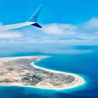 an airplane flying over an island in the ocean at appartement by seb in Santa Maria