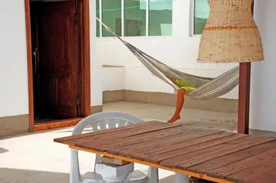 a hammock and a table and a lamp on a porch at Self-catering Apartment w/ Terrace in Tarrafal
