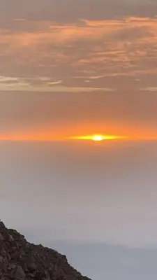 a sunset over the ocean with the sun in the sky at TCHAN LOVe in Portela