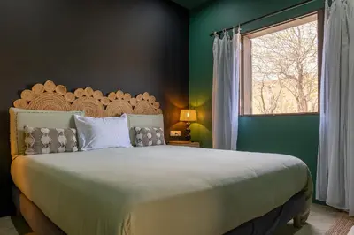 a bedroom with a large bed and a window at Casa Archipel - Lagedos in Ribeira Fria