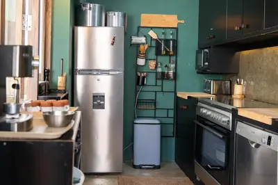 a kitchen with a stainless steel refrigerator in a kitchen at Casa Archipel - Lagedos in Ribeira Fria