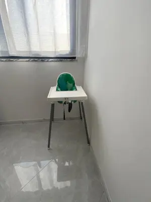 a green stuffed animal sitting on a table in a room at Felicidade apartamento Palmarejo Grande in Praia