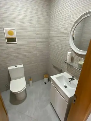 a bathroom with a white toilet and a sink at Felicidade apartamento Palmarejo Grande in Praia