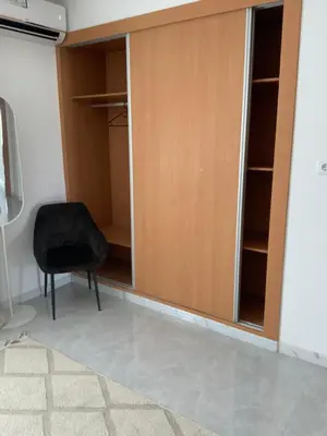 a black chair sitting in front of a closet at Felicidade apartamento Palmarejo Grande in Praia