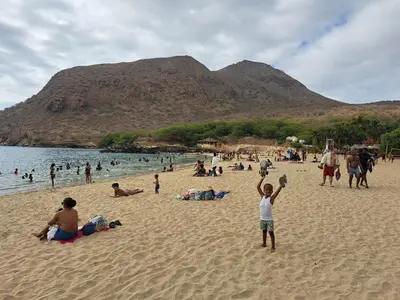 a group of people on a beach with a crowd at Barros Homestay in Tarrafal