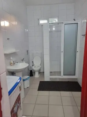 a bathroom with a shower and a toilet and a sink at Casa Cisalta N2 - 5mn Centro City in Praia