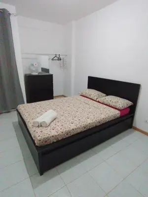 a bedroom with a bed with two towels on it at Apartment 3 minutes from Nelson Mandela Airport in Praia