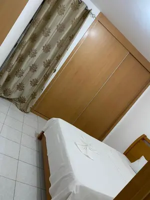 a bed in a room with a wooden door at Apartment 3 minutes from Nelson Mandela Airport in Praia