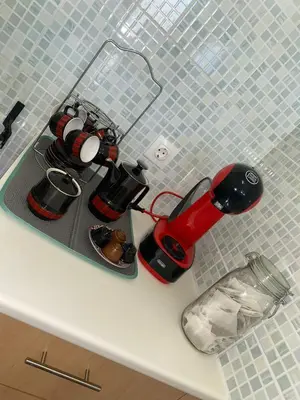 a kitchen counter with a coffee maker on a tray at Apartment 3 minutes from Nelson Mandela Airport in Praia