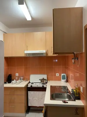 a kitchen with a sink and a stove at Apartment 3 minutes from Nelson Mandela Airport in Praia