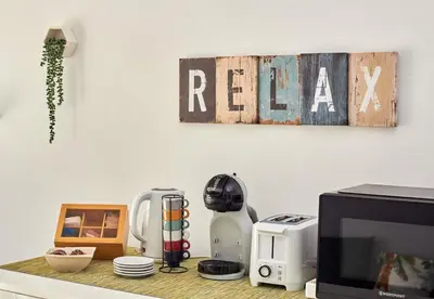 a kitchen counter with a coffee maker and a microwave at Paraiso Tropical wifi and pool Djadsal moradias in Santa Maria