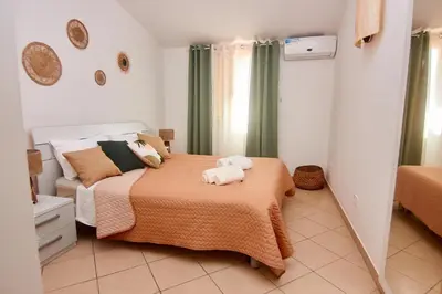 a bedroom with a bed with two towels on it at Paraiso Tropical wifi and pool Djadsal moradias in Santa Maria