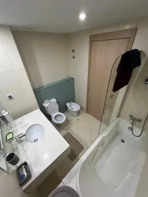 a bathroom with a tub and a toilet and a sink at Soares Appart's in Santa Maria
