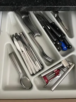 a white tray with silver utensils on it at Soares Appart's in Santa Maria