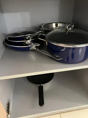 a pot and pans sitting on a shelf at Soares Appart's in Santa Maria