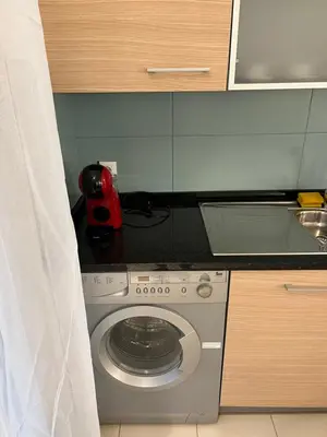 a kitchen with a washing machine in a kitchen at Soares Appart's in Santa Maria