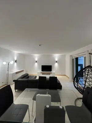 a living room with a couch and a television at Soares Appart's in Santa Maria