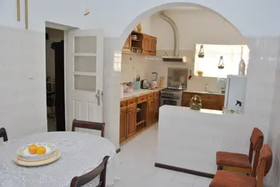a kitchen with a table with a plate of fruit on it at Tambarina Guest House in Mindelo
