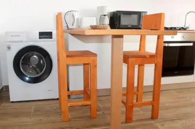 a kitchen with a table and two chairs and a microwave at My Boavista 2 in Sal Rei