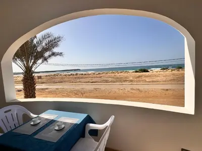 a table and chairs with a view of the beach at Nautilus Cabral Sea view, free Wi-Fi in Sal Rei