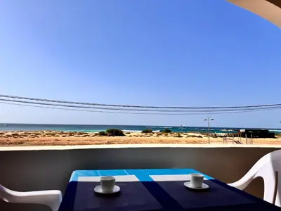 a table and chairs with a view of the beach at Nautilus Cabral Sea view, free Wi-Fi in Sal Rei